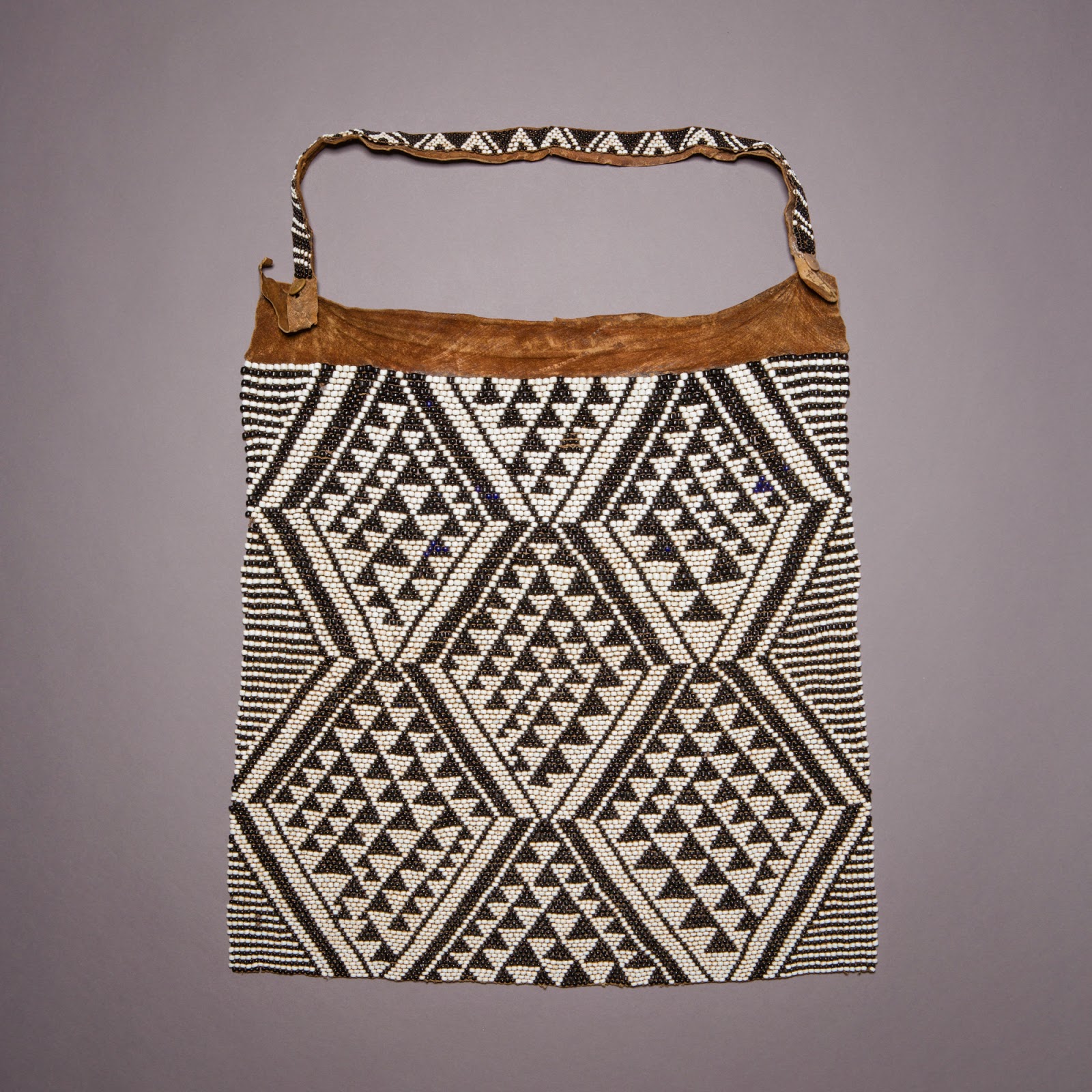 Beaded apron made of black and white beads in a geometric pattern.